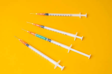 medical syringes on a yellow background.  concept, protect yourself.の写真素材