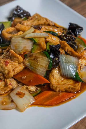 Close up of a plate of homemade tofu with vegetablesの写真素材