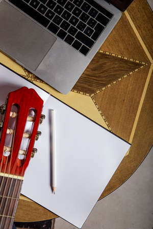 Spanish guitar next to a laptop with online guitar lessons of choiceの写真素材