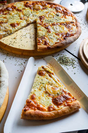Pizza slices on the table on white background. Pizza menu. Vertical pictureの写真素材