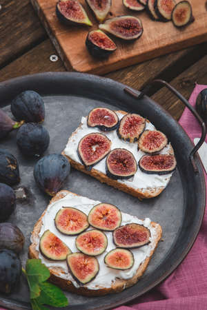 Top view of soft ricotta sandwich with ripe figs served on a tray.の写真素材