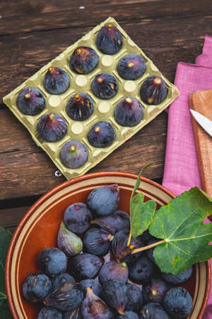 Purple black figs on a rustic wooden table