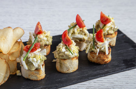 Close up of Sliced Bread Roll Appetizers with Grilled Chicken and Avocadoの写真素材