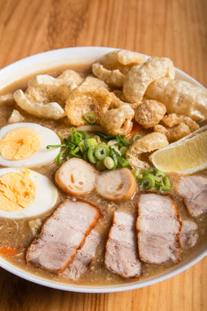 thick egg noodles with fried pork belly or also known as lechon lomiの写真素材