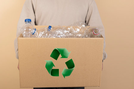 recycling, waste sorting and sustainability concept. Unrecognizable man holding plastic garbage in...