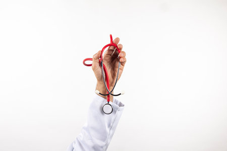 Male hand holding a stethoscope on a white backgroundの写真素材