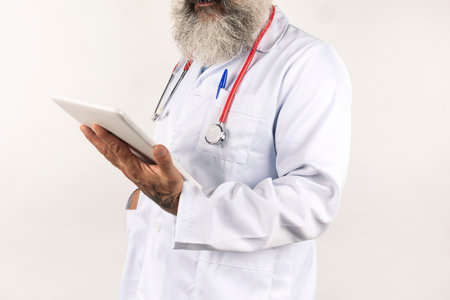 doctor consults the patient's medical history on the tablet on white backgroundの写真素材