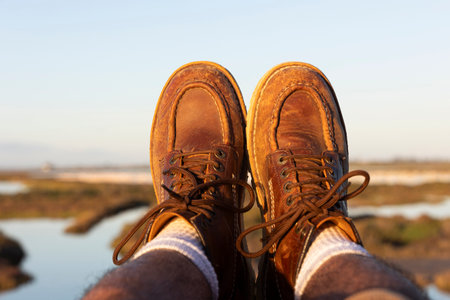 man in boots enjoying wonderful views of the marshes with flamingos. Freedom concept.の写真素材
