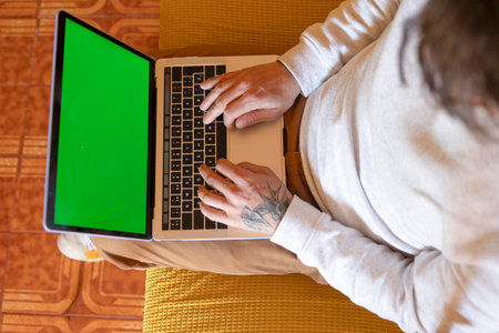 man using laptop on the sofa at home. Remote work conceptの写真素材
