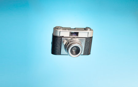 Vintage camera on a light blue background. Photography day conceptの写真素材