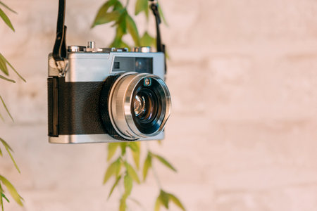 Old black camera hanging on the wall.の写真素材