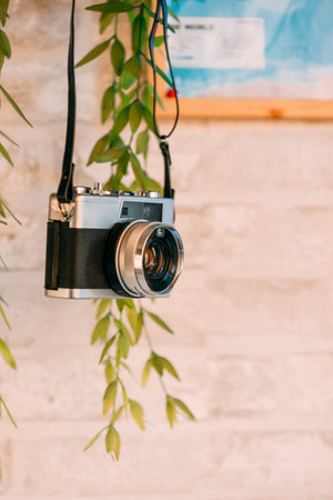Old black camera hanging on the wall.の写真素材
