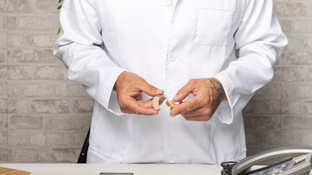 Orthodontic doctor showing hearing aid device for deaf patientの写真素材