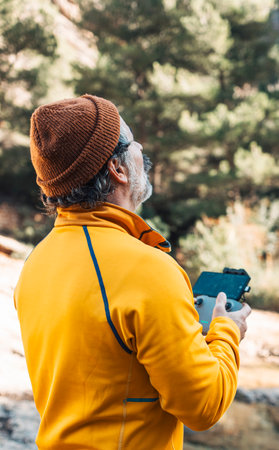 The traveler is piloting a drone in the mountain landscapes