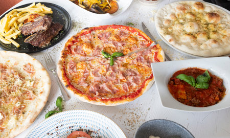 Table spread with various delicious Italian dishes, creating a rich and inviting mealの写真素材