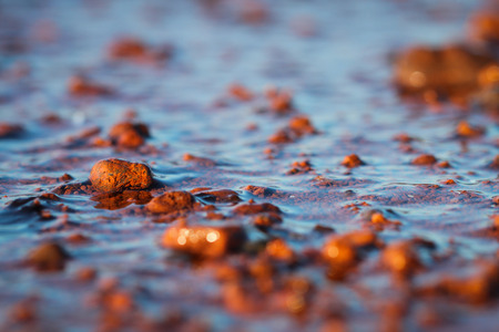 Vibrant red beach rock contrasted with the dark blue sky 