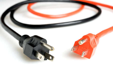 Close up of an orange and a black power plugs の写真素材