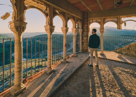Side portrait of a man standing in an abandoned palace in Spainの写真素材