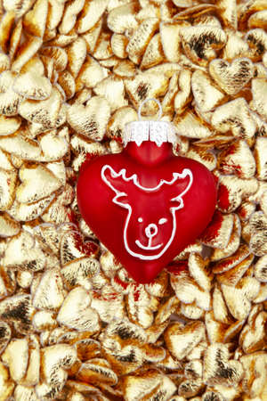 A christmas tree decoration on golden heartsの写真素材