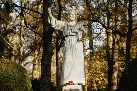 White statue of Christ in autumnの写真素材