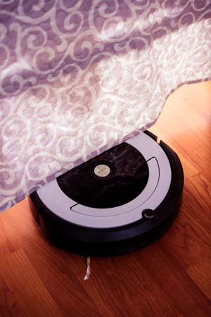 Berlin, Germany, August 29, 2019. irobot vacuum cleaner roomba cleaning under a bed.のeditorial素材