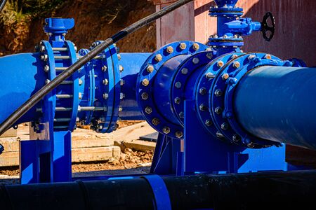 valve on 500mm drink water pipes joined with multi joint members into old pipeline system. Control check of finished repaired piping before covering by clayの写真素材