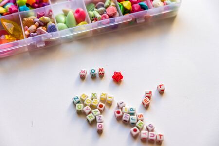 Flat lay of bead pieces, bracelet and necklace for kidsの写真素材