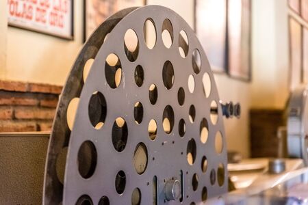 Old movie projector for cinema. Vintage movie camera keep in museum. It is use with retro film. But the body is classic design. The vintage cinema projector is analog and difficult to use it.の写真素材