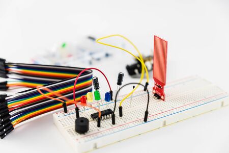 Microcontrollers, chips, resistors and light-emitting diodes on white desktop of hardware engineer. Engineer workplaceの写真素材