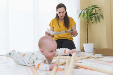 woman riding toy with her baby family at home concept