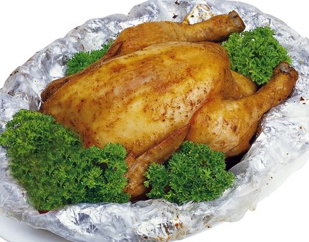 Roasted herbal chicken wrapped in foilの写真素材