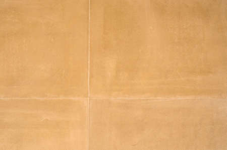 Smooth stone wall blocks of aged brown. The stone has been treated with sand wash.の写真素材