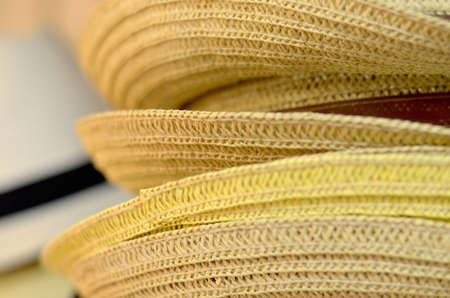 Straw hats stacked on a shown, from a craft store 
