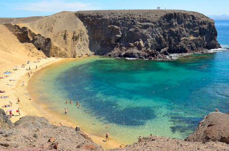 Lanzarote  Canary Islands , Spain - May 7, 2012  Many tourists enjoy Papagayo beach on a sunny spring day  のeditorial素材