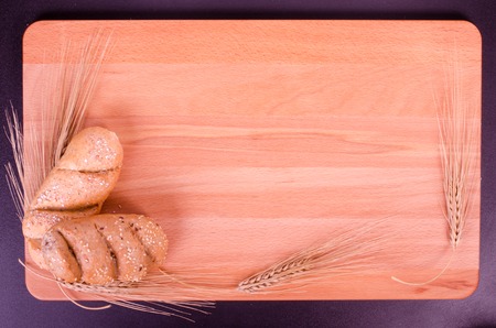 Fresh bread and wheat ears in a woodの写真素材