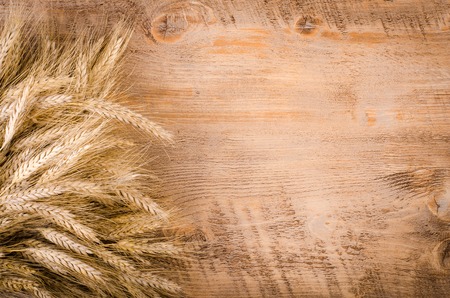 ears of wheat on wooden background. Cardの写真素材