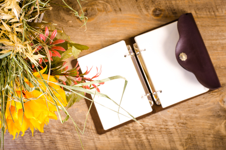 Autumn bouquet  with diary on wooden table. Free space for textの写真素材