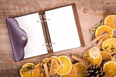 Slices of dried orange, lemon, cinnamon, cloves, cardamomand and pine coneの写真素材