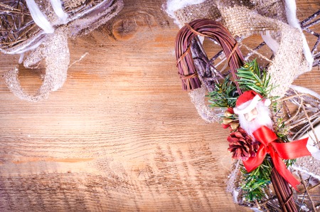 Christmas rustic light boxes on wooden background, snowy wreath. Christmas and New Year decoration frame. Free space for text.の写真素材