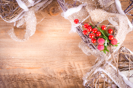 Christmas rustic light boxes on wooden background, snowy wreath. Christmas and New Year decoration frame. Free space for text.の写真素材