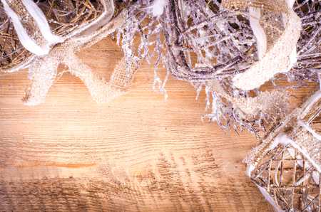 Christmas rustic light boxes on wooden background, snowy wreath. Christmas and New Year decoration frame. Free space for text.の写真素材