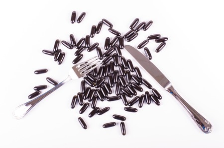 Black capsules blueberry isolated on white backgroundの写真素材