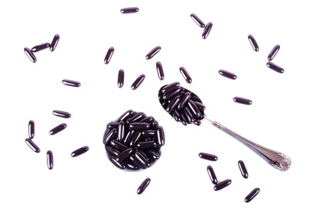 Black capsules blueberry isolated on white backgroundの写真素材