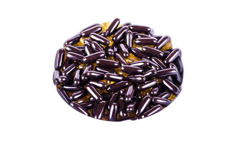 Black capsules blueberry isolated on white backgroundの写真素材