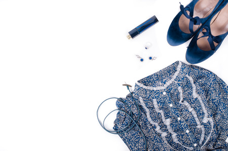 Outfit of stylish ladies clothing on a white background. Blue retro shoes, dress, jewerly and perfume. Free space for your text.の写真素材