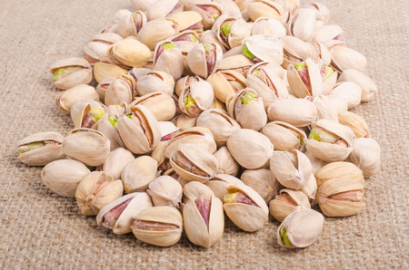 Pistachios on sackcloth, canvas background.の写真素材