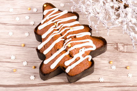 Christmas tree shape biscuit and snowy wreath on wooden background.の写真素材