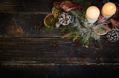 Christmas decoration with candles, christmas ball, ribbon, fir cone, tree, anice star, cinamon. Wooden Background For Copy Space. Vintage Styleの写真素材