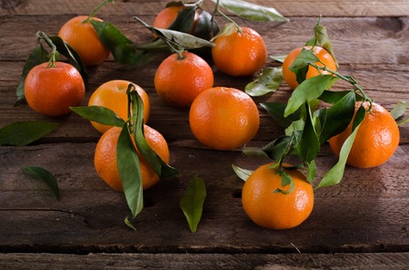 Mandarins Tangerines on wooden background. Free space for your text.の写真素材