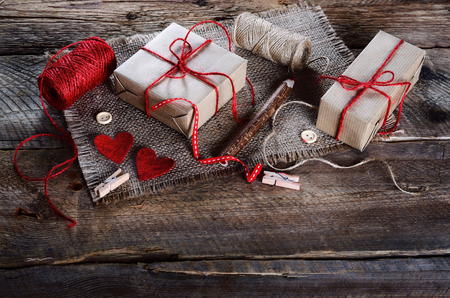 Vintage gift box (package) with blank gift tag on old wooden background.の写真素材
